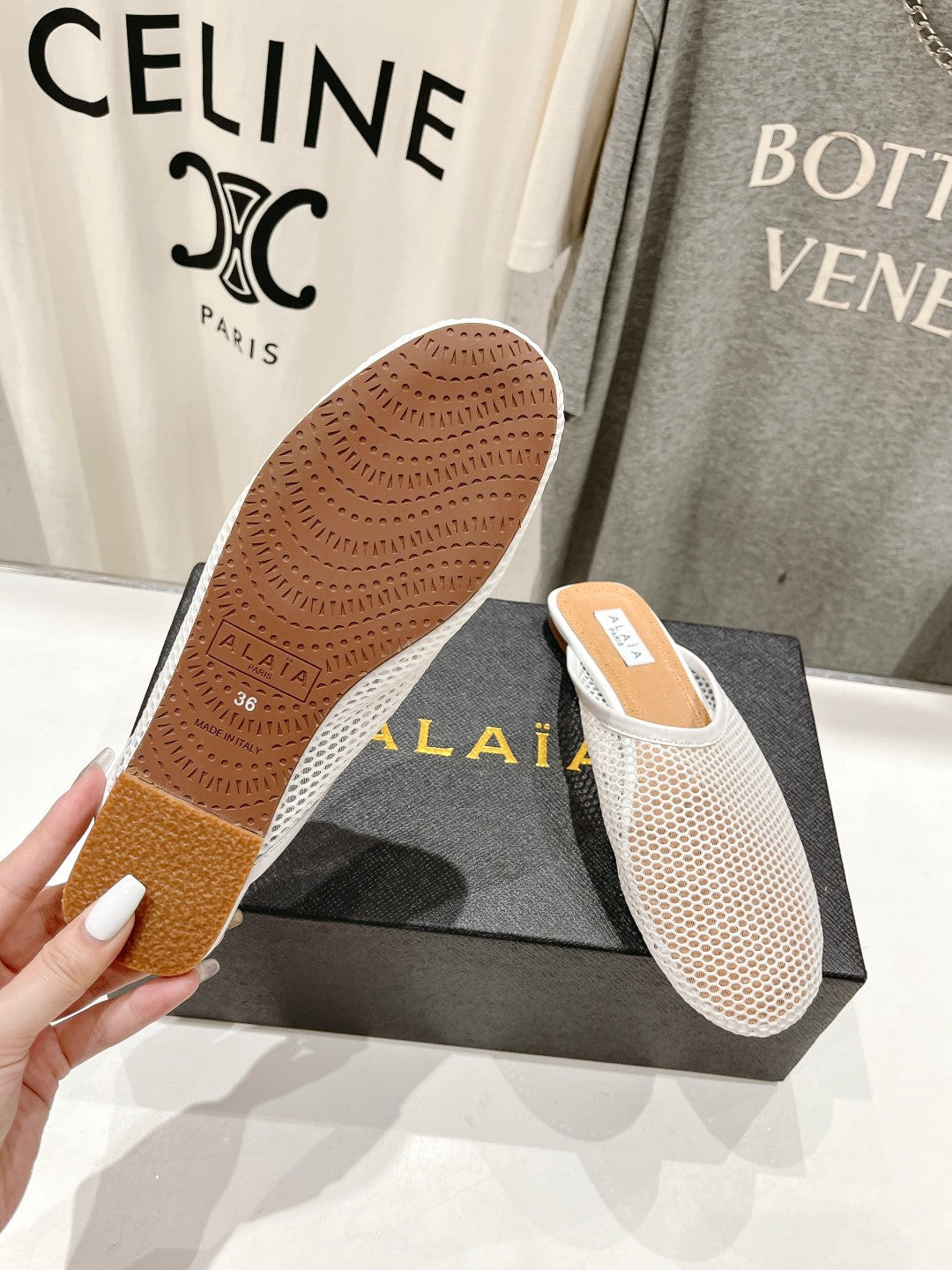 ALAIA FLAT MULES IN WHITE MESH FISHNET